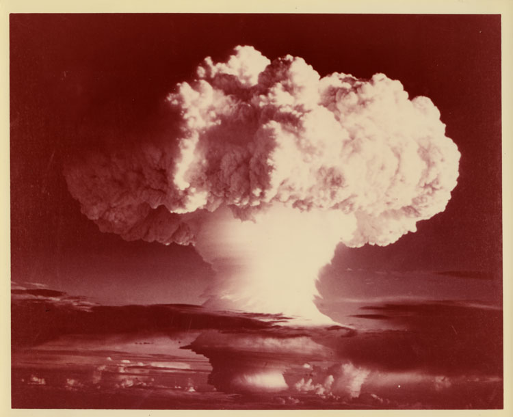 Color photograph of the mushroom cloud of Shot Mike, Operation Ivy, first thermonuclear device test based on Teller-Ulam staged radiation implosion, surface burst, Elugelab Island, Enewetak Atoll, 1 November 1952. Yield 10.4 megatons. No catalog number — verso blank.
