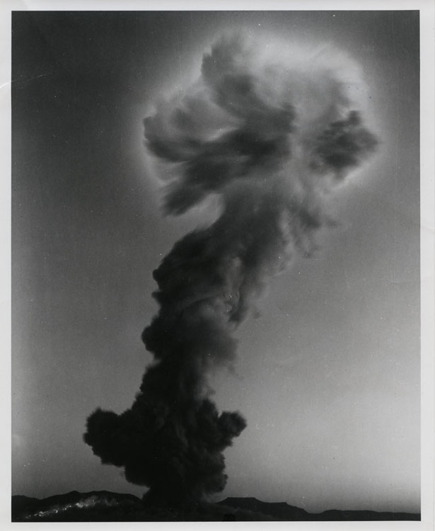 Mushroom cloud of Shot Smoky, 15th full-scale detonation of Operation Plumbbob, separating from its stem above the Nevada Test Site, 31 August 1957. Brush fires visible on hillsides from thermal pulse. UCRL TX-41 thermonuclear development test, 700-foot tower, 44 kt. Lookout Mountain Laboratory, USAF. AEC-57-5830.