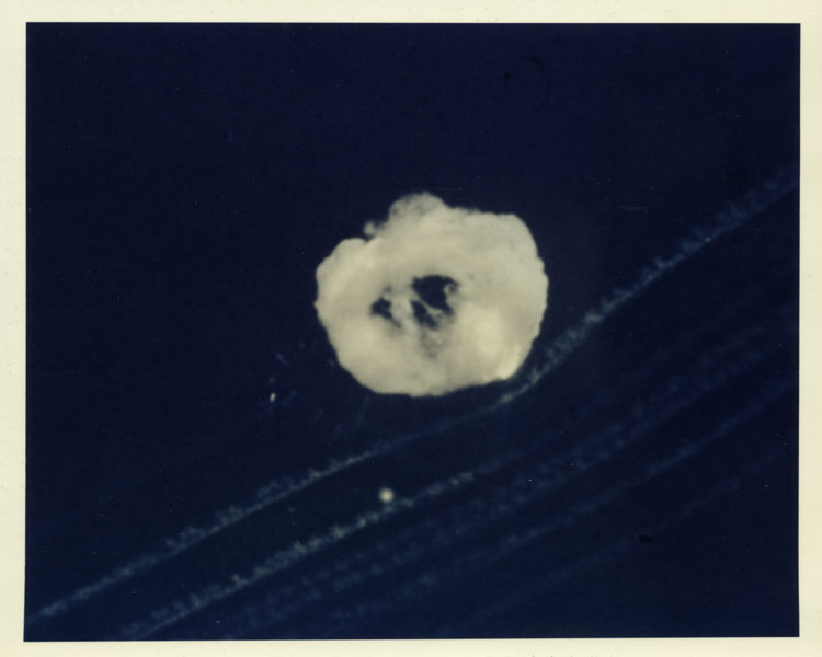 Aerial photograph of the nuclear cloud of Shot HA, tenth detonation of Operation Teapot, B-36H airdrop at 11,160 metres, Area 1, Nevada Test Site, 6 April 1955. LASL air-to-air missile warhead development test, 3.2 kt. Parachute-retarded drop. Reproduction print on Kodak color paper, post November 1961. No catalog number.