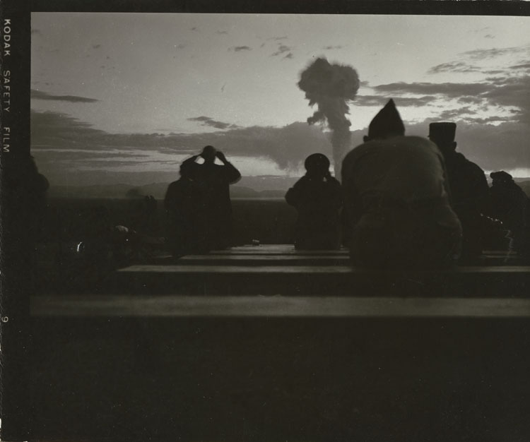 NATO military observers watching the mushroom cloud of Shot Boltzmann, first nuclear detonation of Operation Plumbbob, 152-metre tower, Area 7c, Nevada Test Site, 28 May 1957. LASL XW-40 boosted fission warhead test, 12 kt. Personal or working photograph, Kodak Safety Film.
