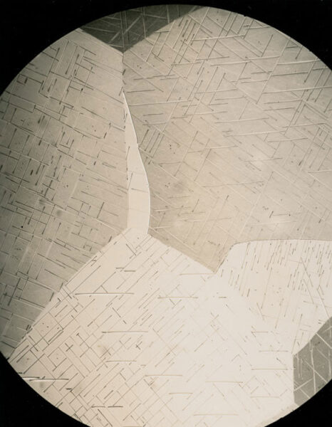 Photomicrograph of a uranium alloy thin section at 250x magnification under light microscopy, showing crystalline grain structure. Eldorado Nuclear Limited Metallographic Laboratory, 1968.