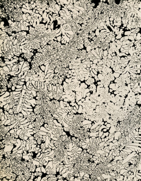 Photomicrograph of a molybdenum-carbide uranium alloy thin section, top-circumference, at 100x magnification, showing crystalline grain structure. Eldorado Nuclear Limited Metallographic Laboratory, 1968.